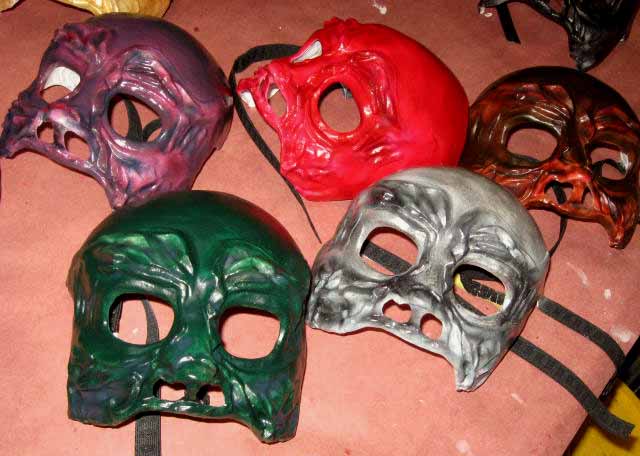 5 finished skull masks in green, gray silver, purple, red and brownish red