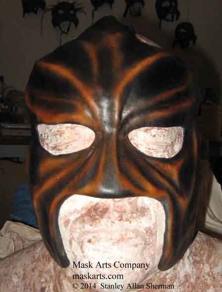 Abyss wrestling mask, front view, black & tan  half mask 